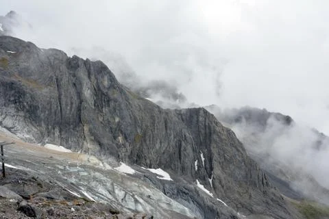 Black mountain with snow in cloud Stock Photos
