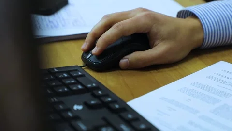 Black mouse, black keyboard. A man clicks on a mouse button Stock Footage 162566124