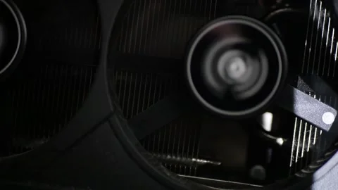 Black multi-fan graphics card operating idle mode close up cooling system detail Stock Footage 320898300