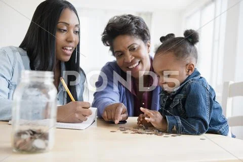 Black multi-generation family counting coins Stock Photos