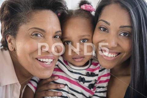 Black Multi-Generation Family Posing Cheek To Cheek