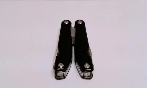 Black multitool folded on a white background Stock Photos