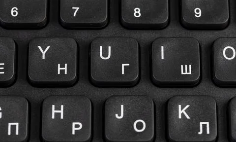 Black new computer keyboard layout with Latin and Cyrillic alphabet, close up Stock Photos