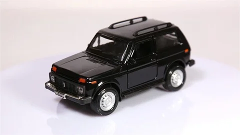 Black Niva scale model russian SUV car is rotating isolated on white Stock-Footage 102086590