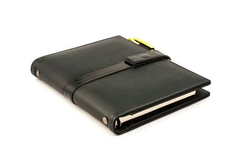 Black note book with ballpoint pen Stock Photos