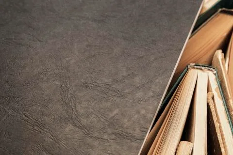 Black notebook lying on the side of books Stock Photos