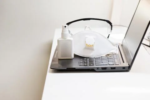 Black notebook with protecting mask and glasses and antiseptic. Coronavirus c Фото