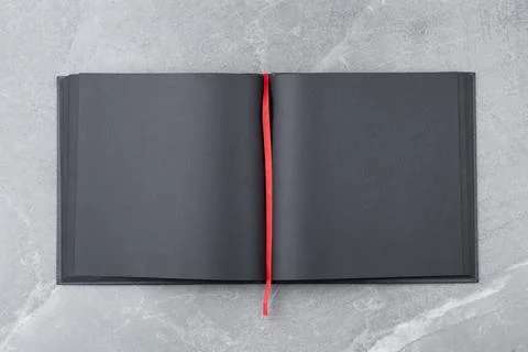 Black notepad on marble background. Stock Photos
