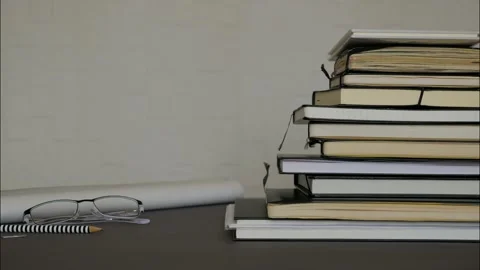 Black notepads stacking up on office table - Stop motion. Stock Footage 130667548