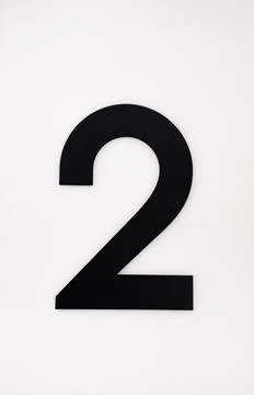 Black number two on white wall Stock Photos