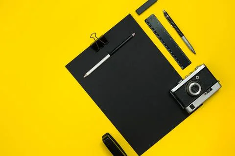 Black objects from the office on a yellow background. Work and creativity. Top Stock Photos