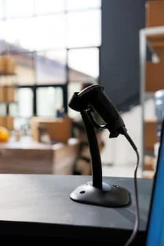 Black office barcode scanner on a desk with blurred modern workspace backgrou Stock Photos