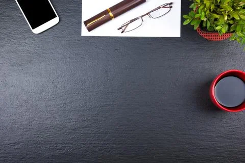 Black Office desk table with computer, pen and a cup of coffee, lot of thin.. Stock Photos