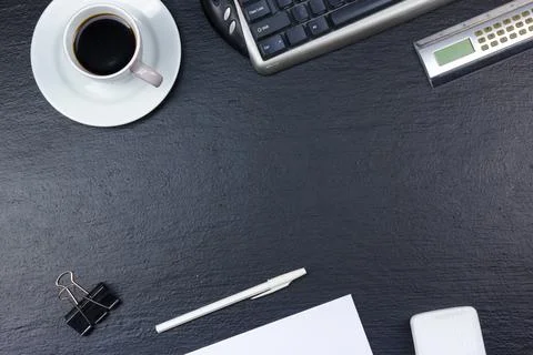 Black Office desk table with computer, pen and a cup of coffee, lot of thin.. Stock Photos