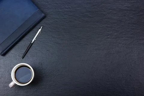 Black Office desk table with computer, pen and a cup of coffee, lot of thin.. Stock Photos