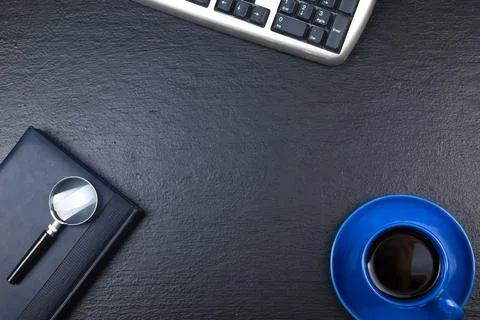 Black Office desk table with computer, pen and a cup of coffee, lot of things Stock Photos