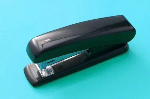 Black Office Stapler Isolated on Blue Green Stock Photos
