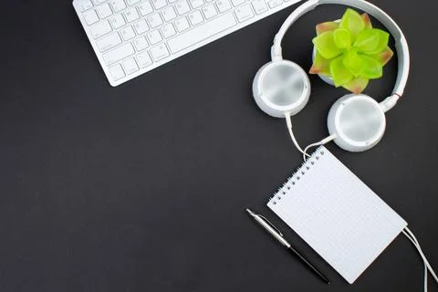 Black office table with computer, pen and a cup of coffee, lot of things. T.. Stock Photos