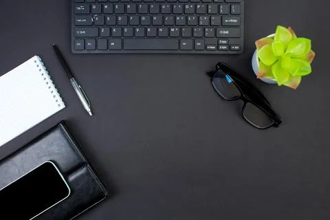 Black office table with computer, pen and a cup of coffee, lot of things. Top Stock Photos