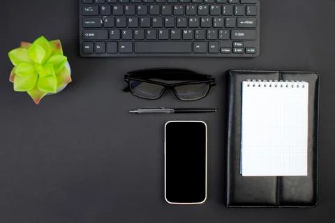 Black office table with computer, pen and a cup of coffee, lot of things. T.. Stock Photos