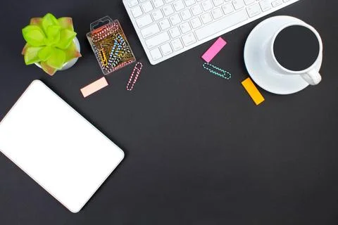 Black office table with computer, pen and a cup of coffee, lot of things. T.. Stock Photos