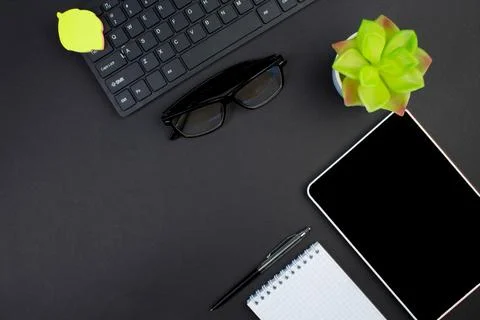 Black office table with computer, pen and a cup of coffee, lot of things. Top Stock Photos