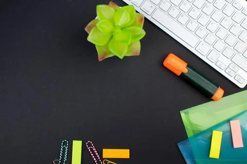 Black office table with computer, pen and a cup of coffee, lot of things. T.. Stock Photos