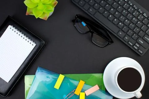Black office table with computer, pen and a cup of coffee, lot of things. Top Stock Photos