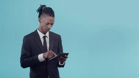 Black office worker is a man in a jacket, white shirt and tie counts on a Stock Footage 159298193