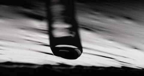 Black oily liquid running down a roughl texture surface Stock Footage 104427369