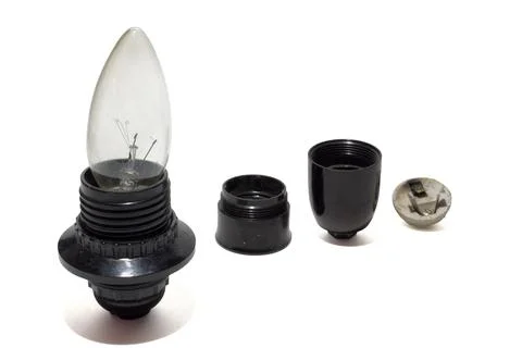 Black old lamp holder with inserted incandescent bulb in the candle shape. .. Stock Photos