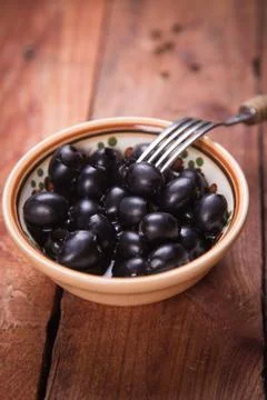 Black olive in dish Stock Photos