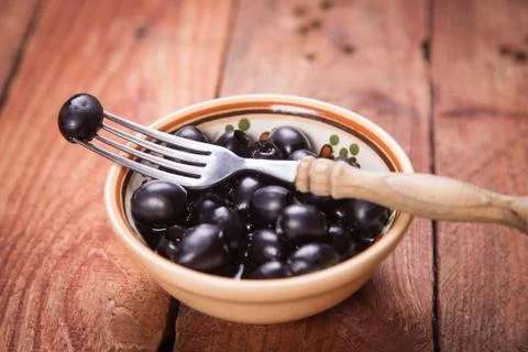 Black olive in dish Stock Photos