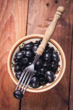 Black olive in dish Stock Photos