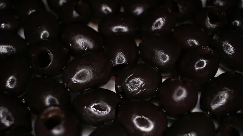 Black olives closeup texture video on rolling rotating looping plate Stock Footage 104324805