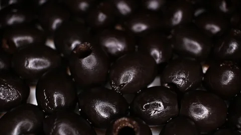 Black olives closeup texture video on rolling rotating looping plate Stock Footage 104335920