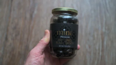 Black olives fruit, dry cured traditional food of Morocco, Moroccan glass jar Stock Footage 336799698