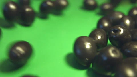 Black olives on green background. Video stock 102049209