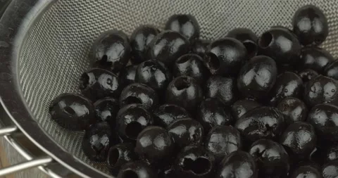 Black olives in a strainer rotating loopable 動画素材 135829275