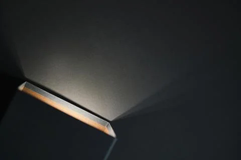 Black opened box , with a yellow light inside of it on a black background Foto stock