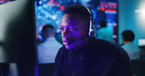 Black operator using computer in hi tech security center Stock Photos