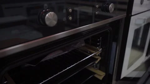 Black oven with metallic knobs 스톡 동영상 297651841