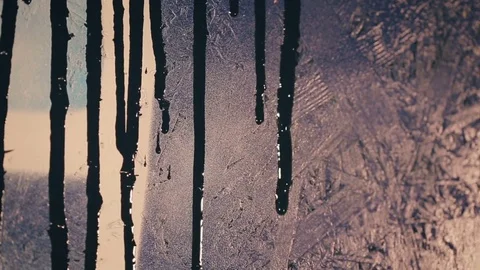 Black paint flows down the colored wall Video stock 82872126