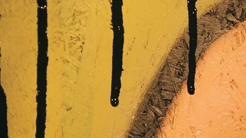 Black paint flows down the colored wall Video stock 82872169