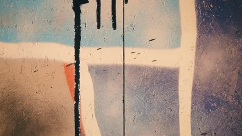 Black paint flows down the colored wall Video stock 82872204