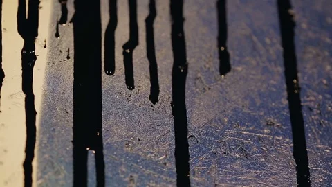 Black paint flows down the colored wall Video stock 82872242