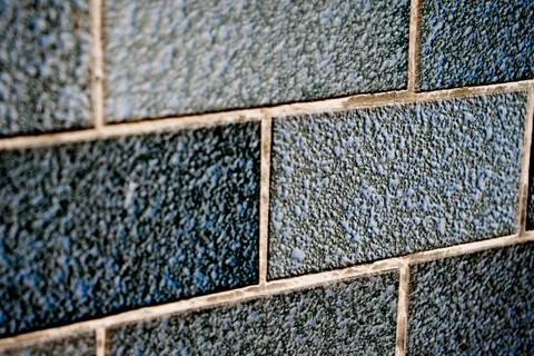 Black Painted Brick Wall with Dramatic Texture and Minimalist Lighting Foto stock