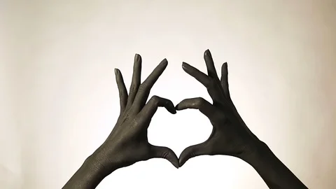 Black painted woman's hand doing heart symbol. Symbol of love, declaration of Stock Footage 100682462