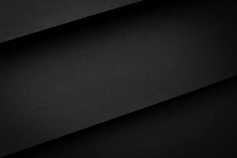 Black paper sheets layered on a flat surface create a simple design Stock Photos