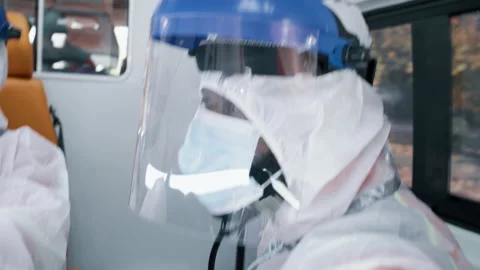 Black paramedic using tablet in ambulance during pandemic Video stock 167963203